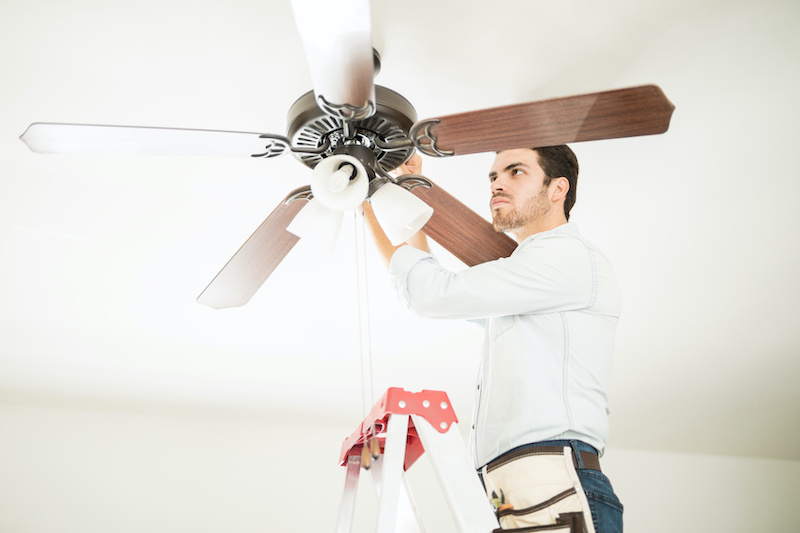 man installing ceiling fan