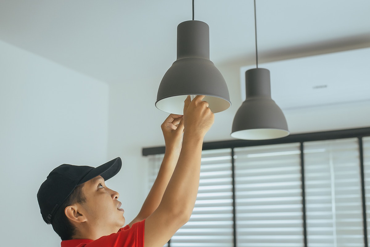 man changing lightbulbs