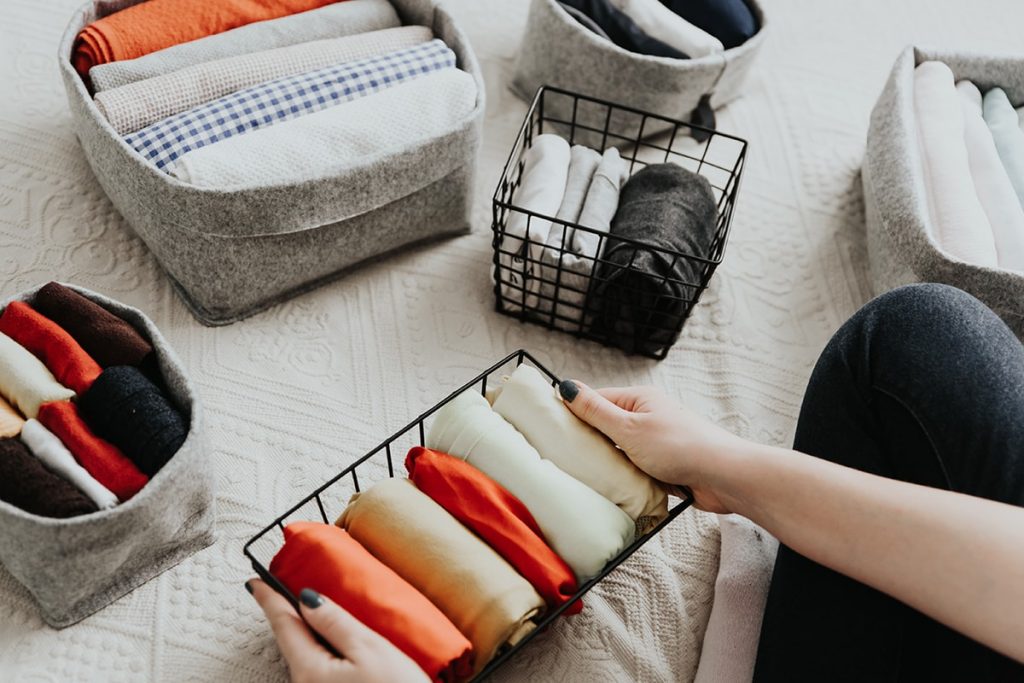 organizing clothes In baskets