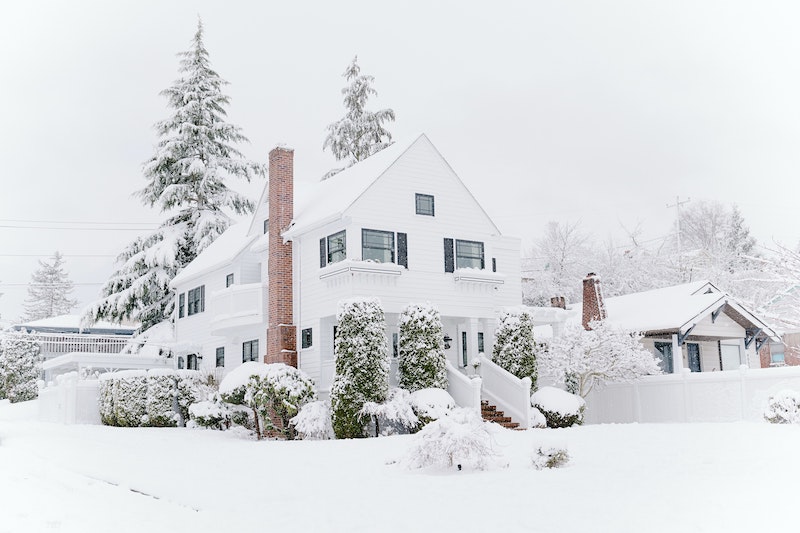 exterior of a white house in winter